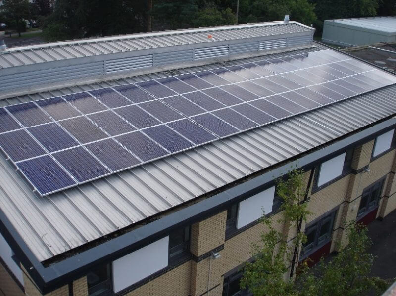 Solar panels on the rooftop of Cheney School, owned and managed by Low Carbon Hub