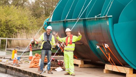 Sandford Hydro construction - the Archimedes screws being floated along the river