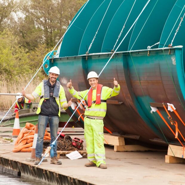 Sandford Hydro construction - the Archimedes screws being floated along the river