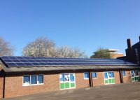 Solar panels on the rooftop of St Barnabus School, owned and managed by Low Carbon Hub