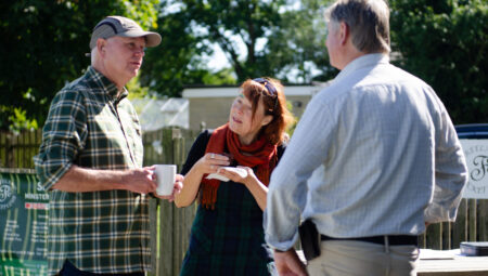 Community members talking with a Low Carbon Hub stall in the background.
