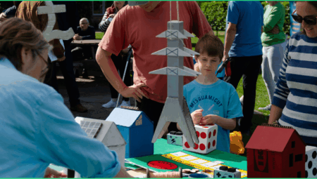 A family learn more about energy systems at a CAPZero event.