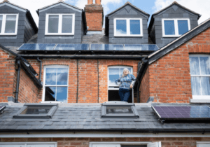 A view of solar panels on the rooftops of houses.
