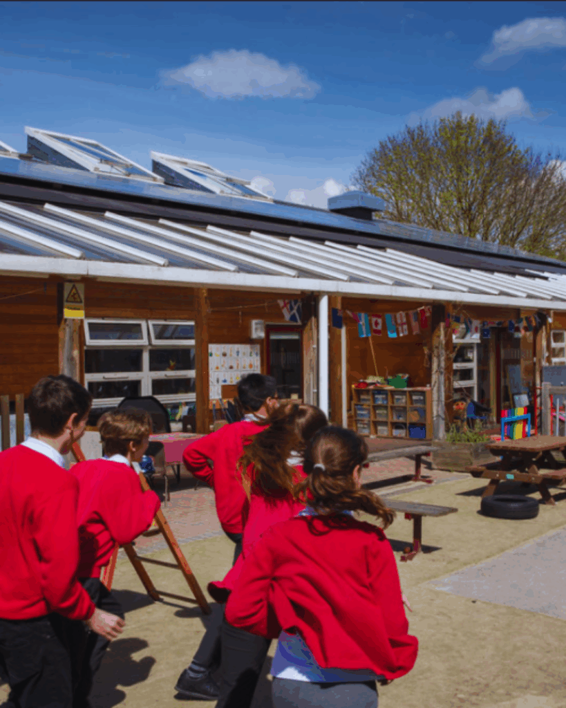 School children playing underneath a solar panel array.